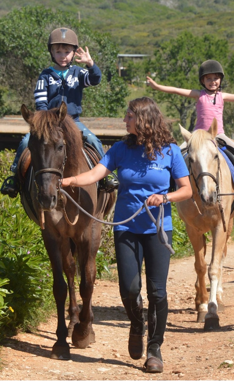Happy kids on a farm ride in Algarve